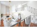 View of the stunning living room with fireplace from the second-story balcony at 3957 S Peach Way, Denver, CO 80237