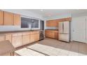 Kitchen with light wood cabinets, stainless steel appliances, and tile floors at 6441 S Eudora Way, Centennial, CO 80121
