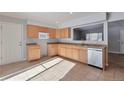 Bright kitchen features ample cabinetry and tile flooring at 6441 S Eudora Way, Centennial, CO 80121