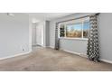 Spacious living area with a large window and a view of the entryway door at 6711 S Race St, Centennial, CO 80122