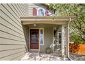 Inviting front porch with stylish details, including a decorative door, complementary sidelight, and stone accents at 5324 S Malta Way, Centennial, CO 80015