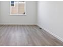 Simple bedroom with neutral walls and wood-look floors at 5091 Hickory Oaks St, Castle Rock, CO 80104
