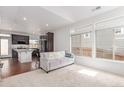 Bright living space features a plush sofa, large windows, and seamless flow into the kitchen area at 10580 Waco St, Commerce City, CO 80022