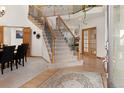 Grand foyer with a staircase, elegant rug, and natural light, creating a warm and inviting entrance at 7724 Kryptonite Ln, Castle Rock, CO 80108
