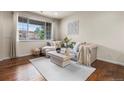 Comfortable living room with a large window offering natural light and cozy furniture at 9071 E Phillips Dr, Centennial, CO 80112