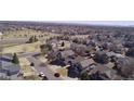 Aerial shot of a residential neighborhood highlighting the community layout and nearby green spaces at 11722 W Belmont Pl, Littleton, CO 80127