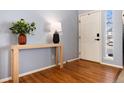 Welcoming entryway with hardwood floors, a console table, and stylish decor for a warm first impression at 11722 W Belmont Pl, Littleton, CO 80127