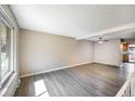 Spacious living room featuring new flooring and a large window letting in natural light at 1791 Quail St, Lakewood, CO 80215