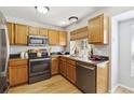 Well-lit kitchen featuring warm wood cabinets, stainless steel appliances, and a window offering natural light at 8510 Union Cir, Arvada, CO 80005
