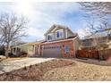 Two-story home featuring neutral siding and a well-manicured lawn on a sunny day at 9703 Ogden Ct, Thornton, CO 80229