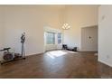 Bright living room with soaring ceilings, tiled floors, and abundant natural light from bay windows at 9703 Ogden Ct, Thornton, CO 80229