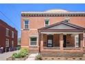 Charming brick home featuring a cozy front porch and well-maintained landscaping at 1021 E 23Rd Ave, Denver, CO 80205