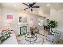 Inviting living room with fireplace, ceiling fan, and ample natural light at 1021 E 23Rd Ave, Denver, CO 80205