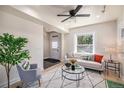 Comfortable living room with a ceiling fan, hardwood floors and bright windows at 1021 E 23Rd Ave, Denver, CO 80205