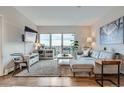 Bright living room featuring modern furnishings, a large balcony, and stylish decor at 1150 Vine St # 1006, Denver, CO 80206