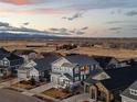Stunning aerial view of a residential neighborhood with mountain views at sunset at 7895 Julsburg Cir, Littleton, CO 80125
