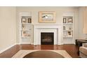 Living room fireplace features built-in shelving and decorative accents around the mantel at 7895 Julsburg Cir, Littleton, CO 80125