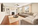 Comfortable living room with fireplace, built-in shelving, and a large sectional sofa at 7895 Julsburg Cir, Littleton, CO 80125