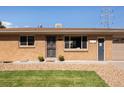 Close up of charming brick home featuring a well-manicured lawn at 5915 W 5Th Ave, Lakewood, CO 80226