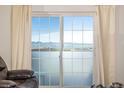 Balcony view through sliding glass doors showcasing mountain landscapes and clear blue skies at 9258 Rockhurst St # 303, Highlands Ranch, CO 80129