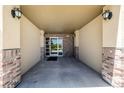 Well-lit entryway with brick accents leads into the condo building at 9258 Rockhurst St # 303, Highlands Ranch, CO 80129
