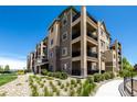 Condo complex boasting well-kept landscaping and multiple balconies at 9258 Rockhurst St # 303, Highlands Ranch, CO 80129