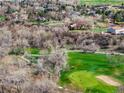 Scenic aerial view of golf course and houses at 11489 W Bear Creek Dr, Lakewood, CO 80227