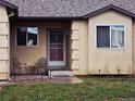 Inviting front porch with decorative metal security door and outdoor seating area at 785 Century Ln, Monument, CO 80132