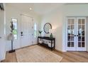 Bright foyer with light wood floors, a decorative rug, and stylish console table at 960 Promontory Cir, Elizabeth, CO 80107