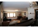 Cozy living room featuring hardwood floors, lots of windows, and an adjacent dining area at 1085 Kingston St, Aurora, CO 80010