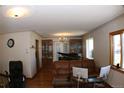 Open-concept living room with elegant chandelier and plenty of seating at 1085 Kingston St, Aurora, CO 80010