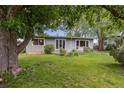 Well-manicured front lawn and a quaint single-story house framed by lush greenery and mature trees at 270 31St St, Boulder, CO 80305