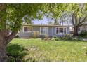 Charming single-story home with well-kept lawn, mature trees, and blooming flowerbeds at 270 31St St, Boulder, CO 80305