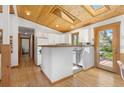 Open kitchen showcasing wood ceilings, white cabinets, and access to an outdoor dining area at 270 31St St, Boulder, CO 80305