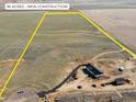 Aerial view showcases this new construction home on 36 acres with a yellow perimeter line at 61800 E 32Nd Ct, Strasburg, CO 80136