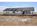 New construction exterior showcasing stone accents and a modern black and white design at 61800 E 32Nd Ct, Strasburg, CO 80136