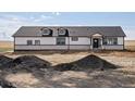New construction exterior showing rock detail and modern, black trimmed windows at 61800 E 32Nd Ct, Strasburg, CO 80136