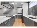 Kitchen area has modern cabinets, stainless appliances and is open to dining area at 2724 Federal Blvd # 2, Denver, CO 80211