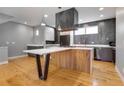 Open kitchen features gray and white cabinets, modern appliances and a large island with seating at 2724 Federal Blvd # 2, Denver, CO 80211