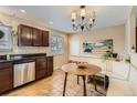 Bright eat-in kitchen featuring stainless steel dishwasher and a built-in breakfast nook at 9068 Dudley St, Broomfield, CO 80021