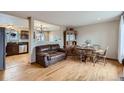 Inviting living room with hardwood floors, a dining area, and seamless flow into the kitchen at 9068 Dudley St, Broomfield, CO 80021