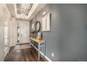 Welcoming foyer with hardwood floors, elegant lighting, a console table, and a view of the front door at 8815 S Tibet Ct, Aurora, CO 80016