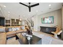 Spacious living room features modern decor, a comfortable leather sofa, and a sleek ceiling fan at 9006 E 60Th Ave, Denver, CO 80238