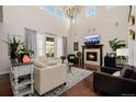 Bright and airy living room with high ceilings, fireplace, and comfortable seating at 15205 W Iliff Ave, Lakewood, CO 80228
