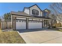 Attractive two-story home featuring a large three-car garage and well-kept lawn on a sunny day at 18646 E Garden Pl, Aurora, CO 80015