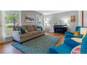 Comfortable living room with a gray sofa, blue accents, hardwood floors, and natural light at 6918 E Easter, Centennial, CO 80112