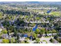 Aerial view of the neighborhood with mature trees, a greenbelt trail, and a nearby elementary school at 6918 E Easter Pl, Centennial, CO 80112