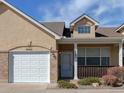 Inviting home featuring a one-car garage and covered front porch at 1343 Villa Grv, Monument, CO 80132