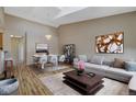 Open-concept living room featuring hardwood floors, chandelier, modern furniture and decor at 1343 Villa Grv, Monument, CO 80132