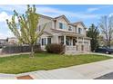 Charming two-story home with a covered front porch, landscaped yard, and an attached two-car garage at 2468 Candleglow St, Castle Rock, CO 80109